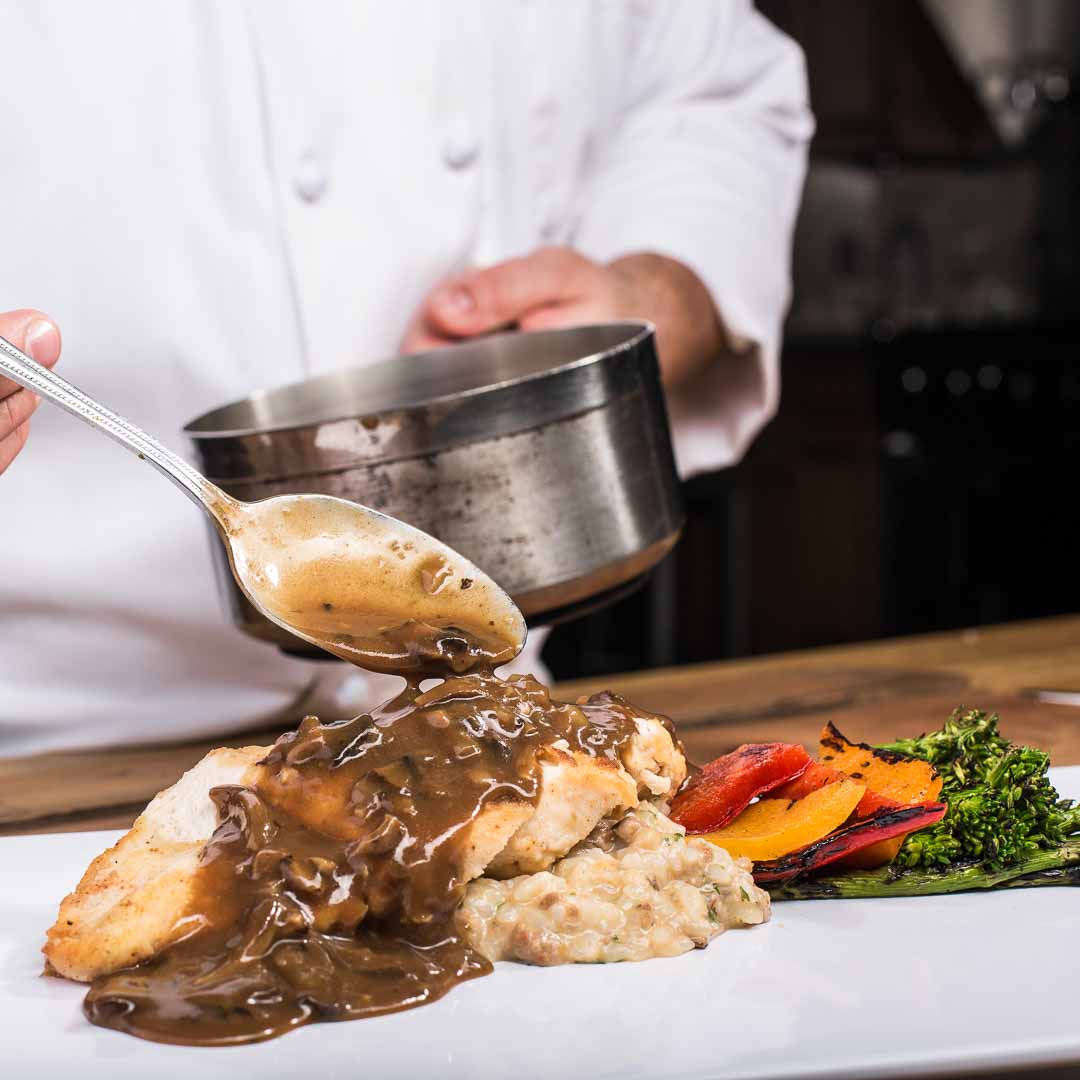 Chef Making Gourmet Chicken Dish