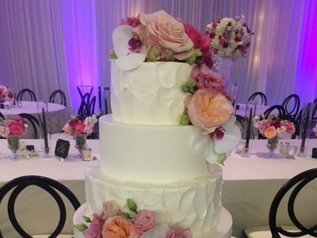 Holiday Market Bakery Custom Wedding Cakes Cake with White Pink and Purple Flowers and Butter Cream Frosting